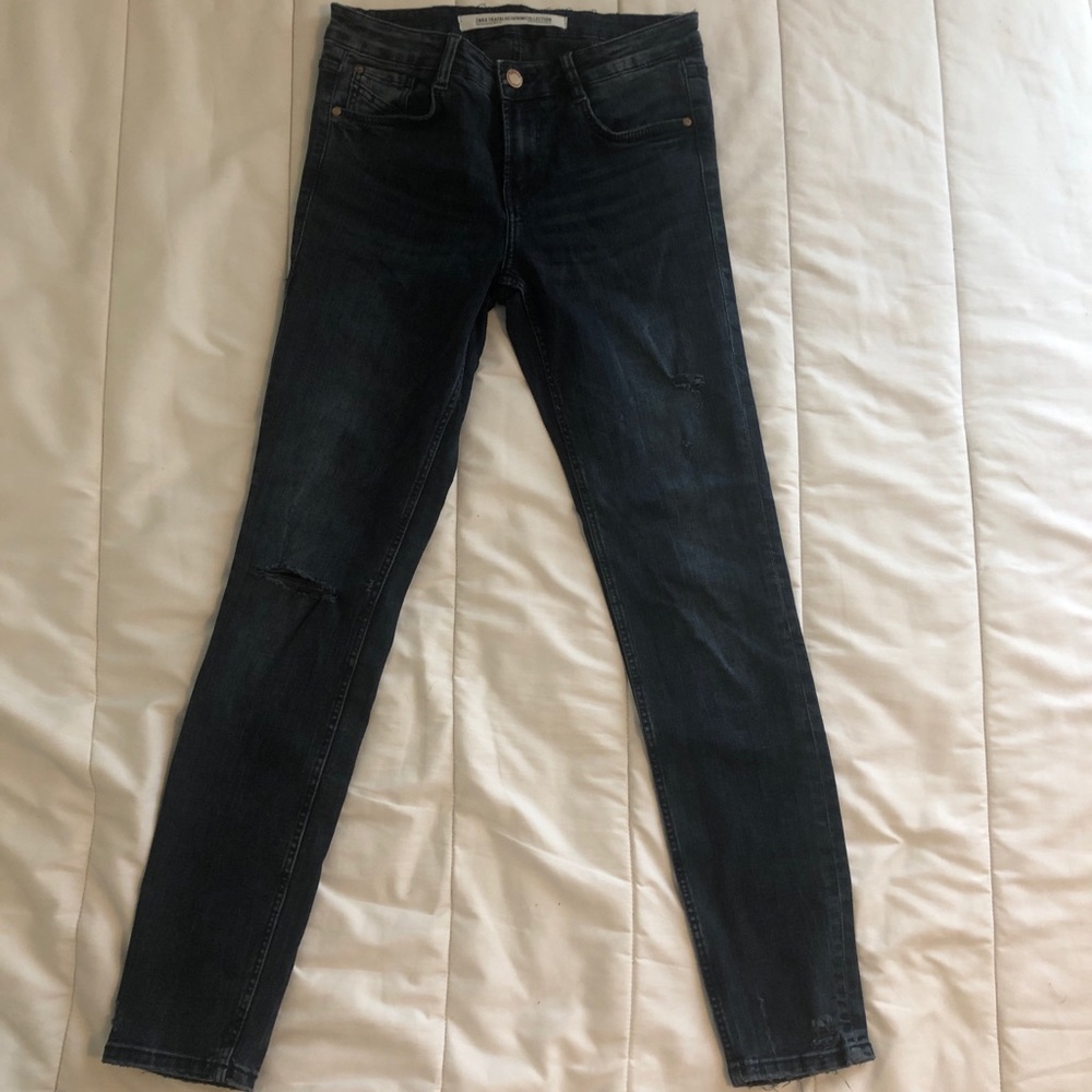 Distressed dark denim jeans